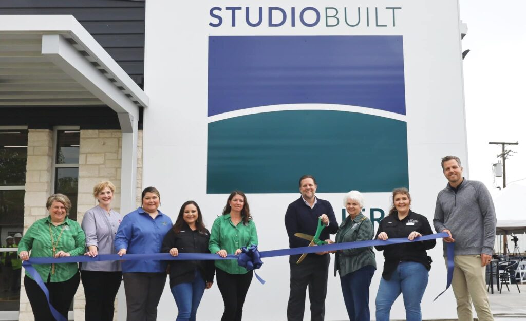 Group ready for ribbon-cutting at STUDIOBUILT