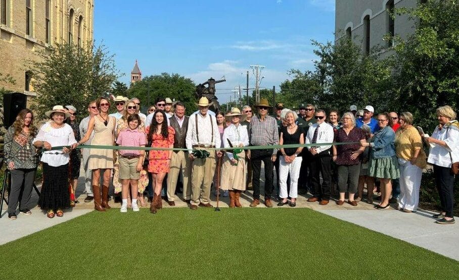 Large group at an outdoor ribbon-cutting event