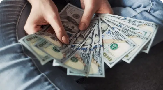 Woman holding a stack of money