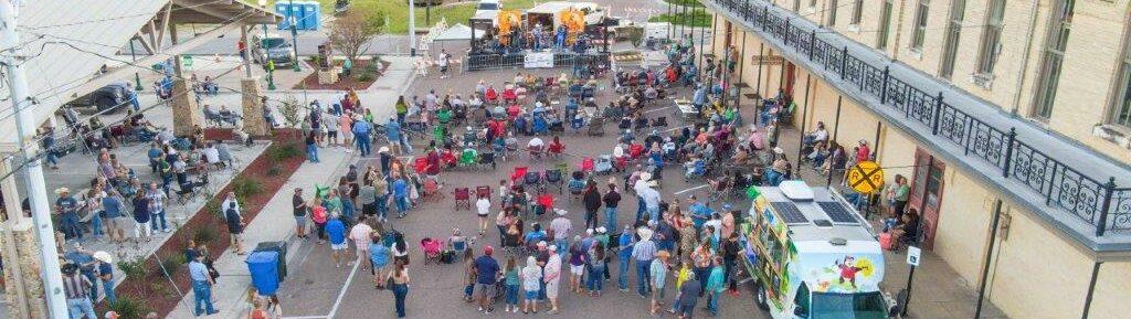 Outdoor street event with people and live music